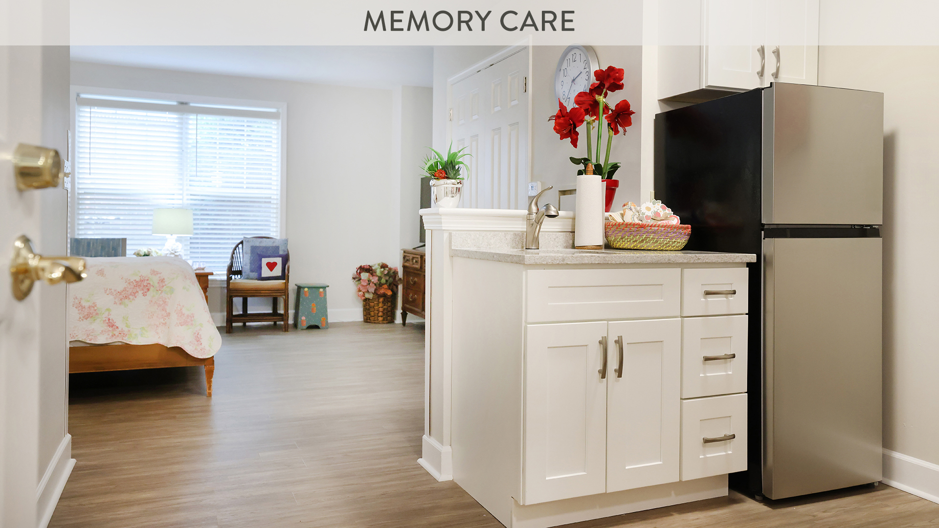 memory care studio with kitchenette and queen sized bed